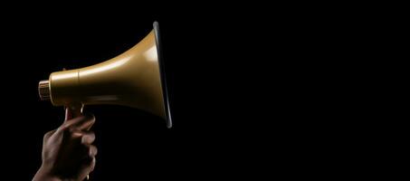 Generative AI, golden megaphone in hand on a empty black background, panoramic image with copy space photo