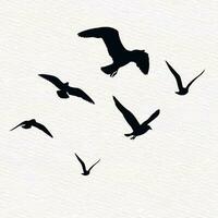 Flock of flying birds in a set of vector silhouettes