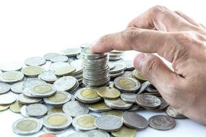 Hand put coins to stack of coins photo