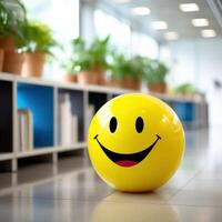 Yellow Smiling face Balloon in the office,blurred background. . photo