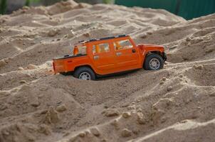 children's toy car on the sand, rally photo