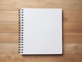 Top view of spiral notebok with pencil on wooden table. Emtry page for text. . photo