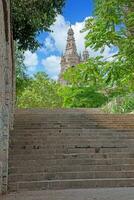 Image of the tower of the Palau Nacional in Barcelona through the surrounding park with old stone staircase in 2013. photo