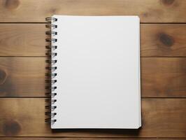Top view of spiral notebok with pencil on wooden table. Emtry page for text. . photo