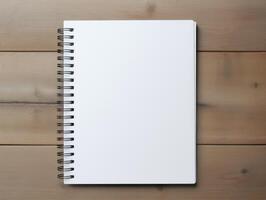 Top view of spiral notebok with pencil on wooden table. Emtry page for text. . photo