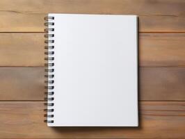 Top view of spiral notebok with pencil on wooden table. Emtry page for text. . photo
