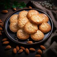 dulce almendra galletas en negro de madera mesa. negro antecedentes. parte superior vista. generativo ai. foto