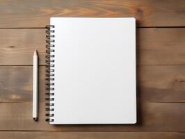 Top view of spiral notebok with pencil on wooden table. Emtry page for text. . photo