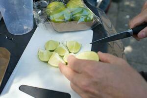 Caucasian hands cutting lime for mojito photo