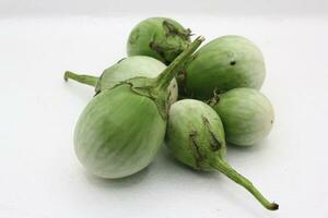 Fresh eggplants in different sizes on a white background photo