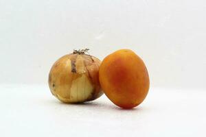 Red tomatoes in a pair with onions on a white background photo