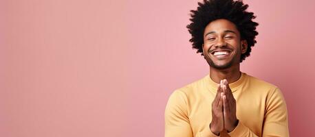 Achieving young black man expressing joy and triumph smiling and clapping hands offering congratulations with applause photo