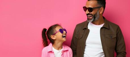 Father and daughter from Latin America dressed casually on pink background with blank space in Mexico photo
