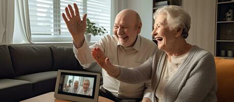 Elderly couple happily video conferencing on tablet photo