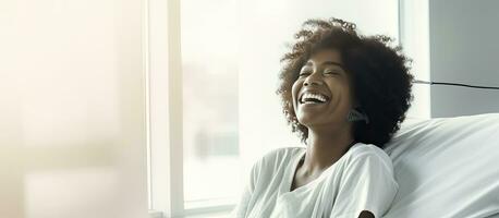 Smiling African American woman in hospital bed photo