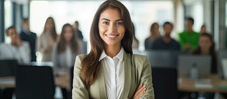 Successful Latin businesswoman smiling with crossed arms standing in a modern office photo