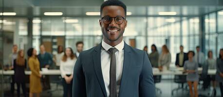 Happy African American CEO in a suit standing at modern office looking at camera in front of company building photo