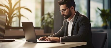 Middle eastern businessman at office typing on computer working on marketing research photo