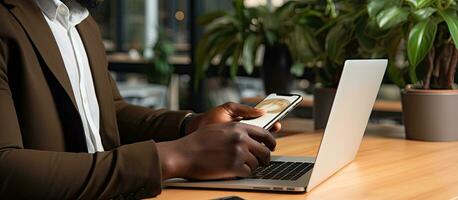 African American man working with code on smartphone at office desk IT developer concept photo