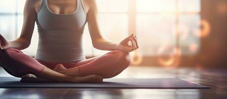 Young woman doing yoga on a fitness mat at the gym photo