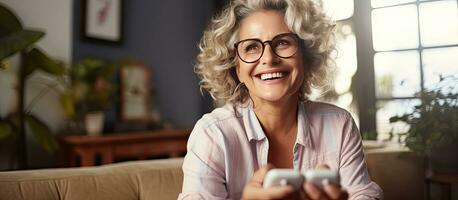 Blonde woman with glasses enjoys playing video games at home and celebrates winning with a smile photo