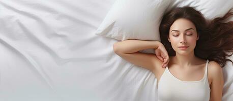 Top view of woman resting in bed with fresh bedding and comfortable mattress photo