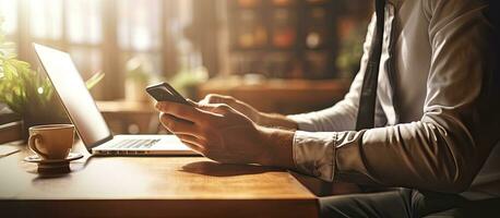 Man using smartphone businessman working on cell phone student typing on phone at desk light flare photo