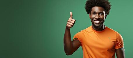 Happy African man at the gym pointing and smiling wearing sports attire with curly hair photo