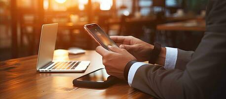 Man using smartphone businessman working on cell phone student typing on phone at desk light flare photo