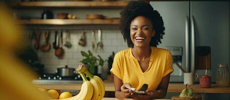 A black woman films a cooking video while happily cutting bananas in her kitchen photo
