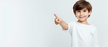 Young girl pointing with a smile on a white background symbolizing advertising education and good ideas photo