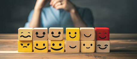 Customer selects smiley face and sad face icons on wooden cube symbolizing service rating and satisfaction Copy space available photo