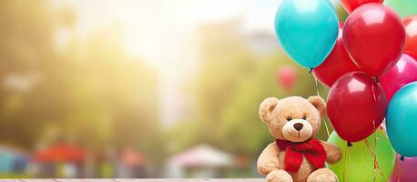 Little girl with autism happily playing with her best friend a teddy bear while holding colorful helium balloons in a green park playground with copy s photo