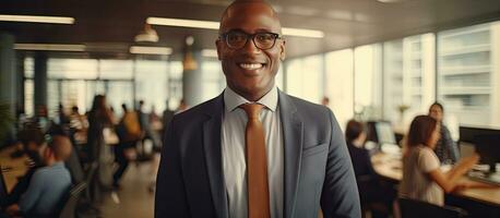Happy African American CEO in a suit standing at modern office looking at camera in front of company building photo