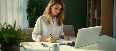 Young businesswoman managing finances and doing paperwork photo