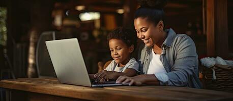 A mother and son working on homework together using a laptop unchanged photo