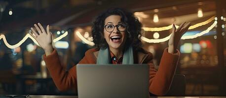 An enthusiastic middle aged woman working on her laptop at night happily pointing to the side with open palms to display a copy space for advertising purp photo