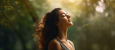 Backlit park with woman stretching profile view of upper body and copy space on right photo