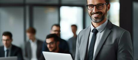 Happy businessman with glasses and laptop on grey background Business and leadership concept Advertisement banner photo