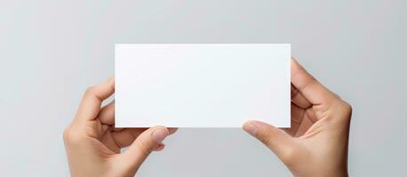 Caucasian woman s hand holds white card for business purposes photo