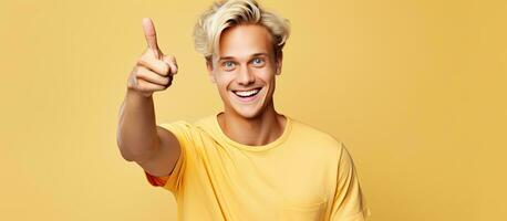 Blond man happily pointing to an idea feeling carefree photo