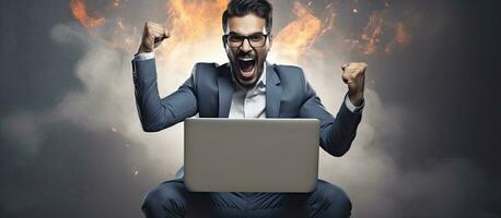 Happy trader using laptop and celebrating success overjoyed man shaking fists cheering big profit photo