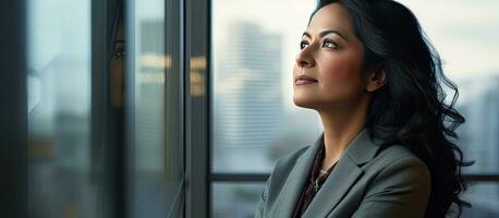 Successful businesswoman in formal wear contemplating copy space photo