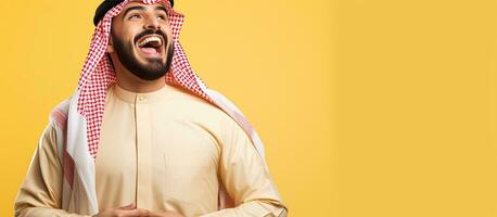 Arab man confidently points towards copy space on yellow background for designers to add text or logos photo