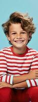 Happy boy in stylish polo shirt smiling and looking sideways on skateboard against blue background with room for text photo