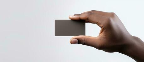 Hand of biracial man holding a black business card with empty area on white background representing the idea of business stationery and writing space photo