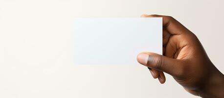 Biracial man s hand with blank business card on white background representing business and stationery photo