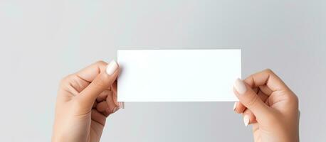 Caucasian woman s hand holds white card for business purposes photo