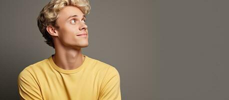 Blond man daydreaming and looking towards empty space photo