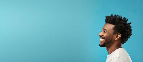 Side view of young African American man smiling and looking aside isolated on blue background with copy space photo